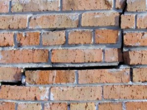 Brick wall with big crack in it