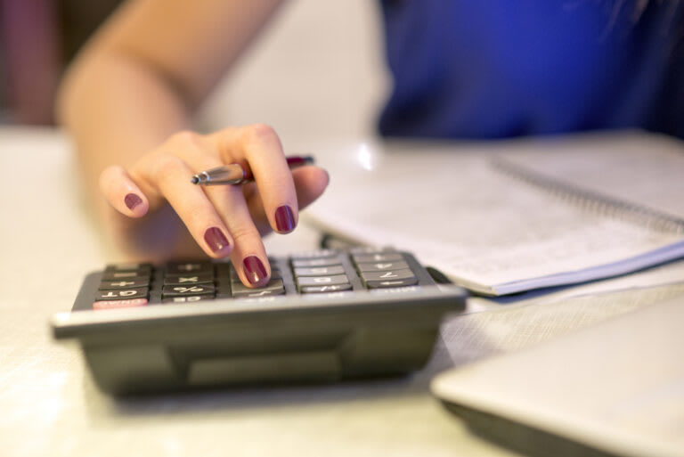 Close up of female accountant or banker making diminishing value calculations